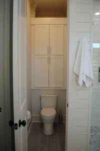 Mt. Pleasant, Master Bathroom toilet room with custom cabinet storage and countertop above toilet.