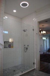 Mt. Pleasant, Master Bathroom custom walk-in shower with subway style white wall tiles and grey marble hexagonal floor tiles. Moen 90 Degree square showerhead.    Round Fan light with bluetooth speaker.