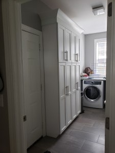 G & J Laundry Room, Custom floor to ceiling storage with power outlets inside.
