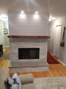 Isle of palms, white quartz fireplace, with slate hearth, cedar mantle and shiplap finish on top.