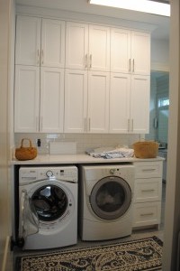 Mt. Pleasant, Custom laundry room upper and lower cabinets.  With front load washer dryer and custom countertops.