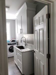 G & J Laundry Room, Laundry sink/ Dog washing sink, with metal backsplash and custom upper and lower storage.