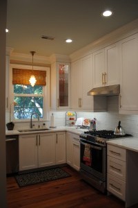 Trumpet Vine, Kitchen, custom glass and brass wire door, uppers with crimson painted interiors.