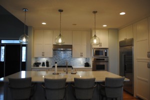 Seaside Kitchen and island, with light blue pearlescent mosaic Backsplash  Dining room view 