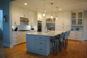 Seaside Kitchen and island with light blue pearlescent mosaic Backsplash, Living room view