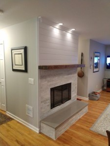 Isle of palms, white quartz fireplace, with slate hearth, cedar mantle and shiplap finish on top.