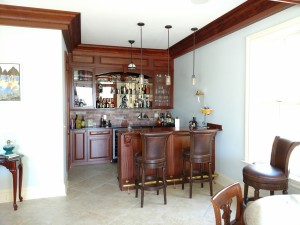 Drew, Custom bar area with Sapele bar, cabinets and doors.  Pendent lighting and glass doors with interior cabinet lighting.