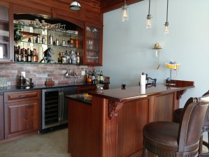 Drew, Custom bar area with Sapele bar, cabinets and doors.  Pendent lighting and glass doors with interior cabinet lighting.